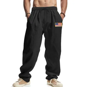 Men's casual black linen baggy trousers featuring an American flag patch detail. New.