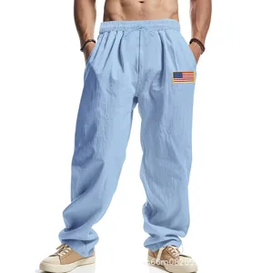Men light blue linen casual wide leg pants with US flag patch, comfortable streetwear trousers.