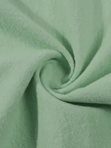 Light green linen fabric detail shot, perfect for crafting breathable summer casual shirts.