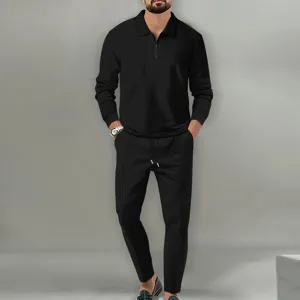 Men's black waffle knit long sleeve zip polo shirt and trousers two piece outfit detail.