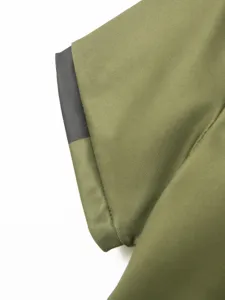 Close up view of the army green polo shirt sleeve cuff featuring dark grey contrast trim.