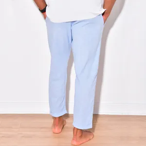 Back view detail of light blue men's casual linen pants with rolled cuffs and breathable fabric.