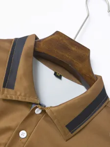 Detailed shot of a brown men's polo shirt with contrast collar stripes and buttons.