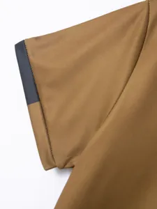 Detailed close-up view of the brown mens polo shirt sleeve with dark contrast cuff trim.