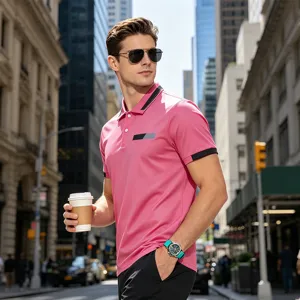 Close-up of men's pink polo shirt with contrast collar and chest design in urban street setting.