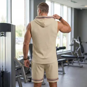 Men waffle knit sleeveless hoodie shorts set, beige gym activewear outfit with striped trim.