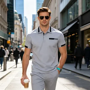Detailed shot of a stylish grey men's casual polo shirt set worn by a model walking outdoors.