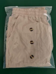 Detail view of men's casual cotton linen cargo shorts in light khaki with decorative buttons.