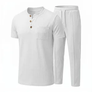 Detailed view of men waffle knit short sleeve henley shirt and casual pants in pure white.