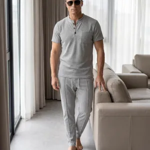 Detail view of men waffle knit short sleeve henley shirt and casual pants set in light grey.