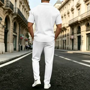 Detail shot of the men's white waffle knit short sleeve top and pants set on a European street.