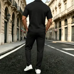 Detail shot of black waffle knit texture on men short sleeve polo shirt and casual pants in street style.