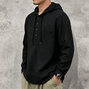 Detail shot of men's black long sleeve linen hoodie with front buttons and adjustable drawstring.