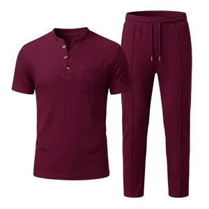 Close-up details of men's waffle knit short sleeve henley shirt and casual pants set.