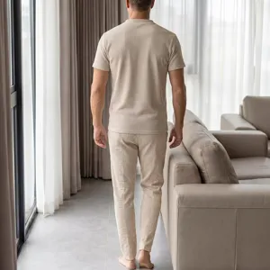 Back view of men's beige waffle knit short sleeve top and casual pants lounge set.