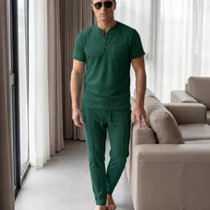Detail shot of men's dark green waffle knit short sleeve henley shirt and lounge pants set.