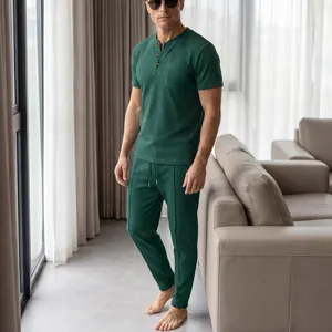 Detailed view of men's green waffle knit short sleeve henley shirt and lounge pants set.