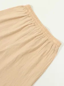 Men's casual cotton linen pants elastic waistband detail closeup, breathable summer wear.