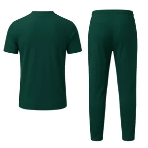 Dark green waffle knit fabric detail showing the textured short sleeve shirt and trousers fabric.