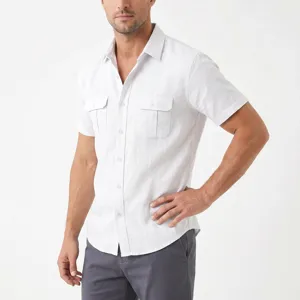 Detailed view of white short-sleeve button-down shirt with dual utility pockets and lapel.
