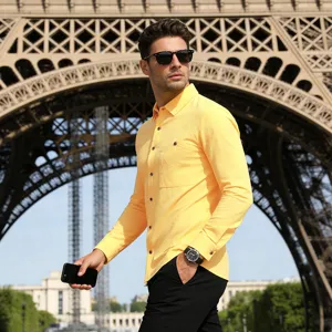 Close-up of men's yellow long-sleeve linen shirt with chest pocket in outdoor setting.