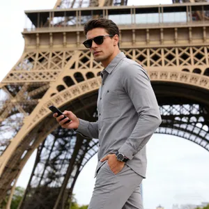 Outdoor detail shot of a man wearing a grey long sleeve linen shirt in Paris, lifestyle view.