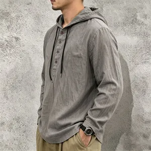 Close-up detail of the men's grey linen hooded shirt featuring front buttons and drawstrings.