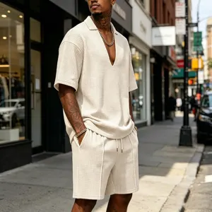 Detail view of men's casual waffle knit V-neck polo shirt and shorts set in street scene.