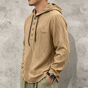 Close-up detail of mens casual long sleeve hooded linen shirt with drawstring and buttons.
