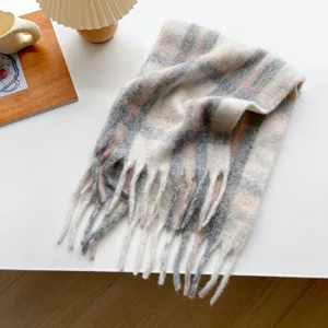 Detailed view of the soft winter plaid tassel scarf showing cozy fabric and fringe texture.