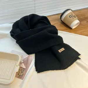 Black knitted cashmere-feel scarf detail, cozy winter neck warmer with brand label design.
