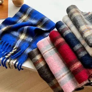 Detailed view of cozy checkered tassel scarves featuring soft and thick winter warm fabric.