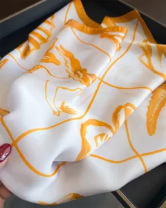 Elegant white silk square scarf with orange abstract print, stylish resort neck wrap for women.
