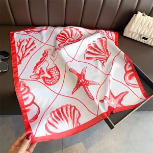 Detailed view of a red and white seaside vacation printed silk square scarf with marine motifs.