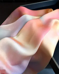 Gradient silk scarf detail close-up, soft pastel pink and orange fabric, elegant draped texture.