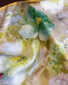 Gros plan détaillé d'un foulard floral en similicoque douce montrant texture et belles couleurs.