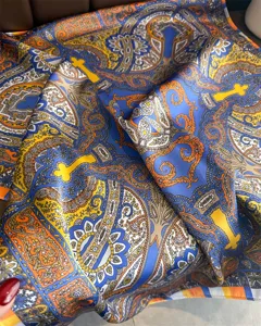 Retro paisley print silk scarf detail, vibrant blue and orange baroque design, smooth satin fabric.