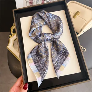 Close-up shot of a vintage paisley print silk square scarf, elegant neck accessory detail.
