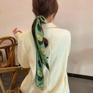 Green avocado print hair ribbon elegant hair accessory styling and close-up detail view