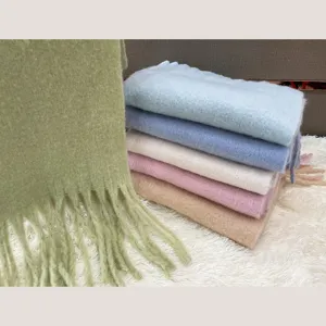 Colorful fluffy mohair winter scarf detail showing soft texture, tassel edge and vibrant hues.
