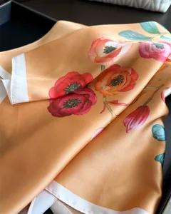 Elegant orange floral silk square scarf with vibrant poppy print, perfect for neck or head wear.