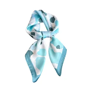 Blue leopard print silk square scarf elegantly tied, stylish neckerchief for women fashion.