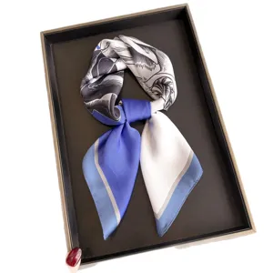 Elegant color-blocked silk scarf with artistic line print, perfect for neckwear or head wrap.