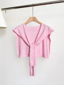 Pink knit hollow floral shawl cardigan, stylish layered accessory for spring and summer outfits.