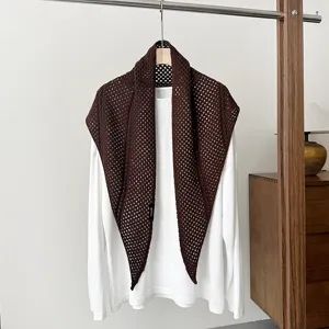 Brown wool-blend hollow knit triangular scarf shawl detail, elegant winter accessory.