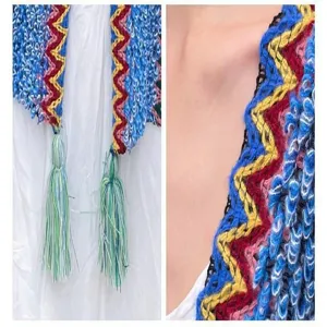 Ethnic style knitted shawl detail, colorful zigzag pattern with tassels for travel wear.