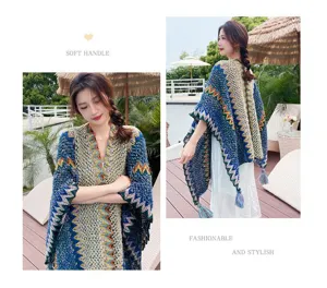 Detailed view of women's ethnic style knitted shawl cape with colorful geometric patterns.