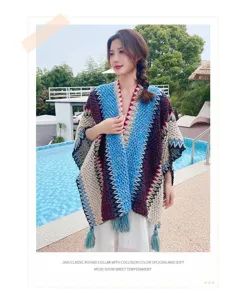 Detailed view of colorful knit poncho featuring vibrant color splicing and soft tassel details.