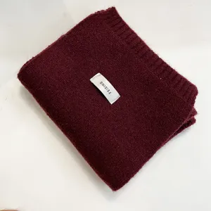 Cozy solid color knitted winter scarf for women and men, soft warm neck warmer clothing item.