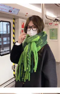 Green fuzzy plaid winter scarf detail, cozy warm thick neckerchief closeup shot in subway scene.